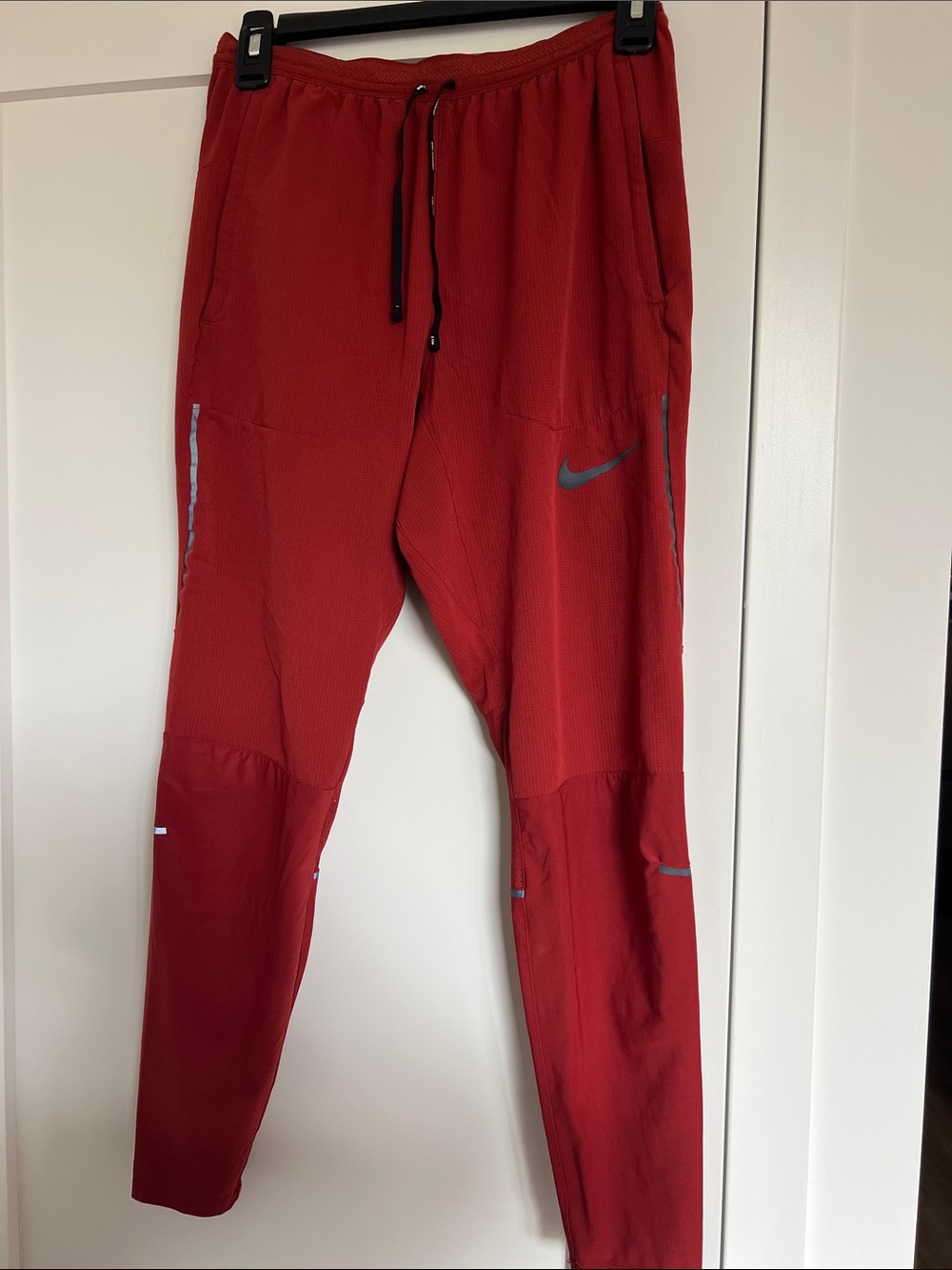 Nike Men's Red Performance Jogger Pants with Reflective Swoosh